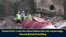 Visuals from crash site show broken tail end, empennage, charred BJ hostel building