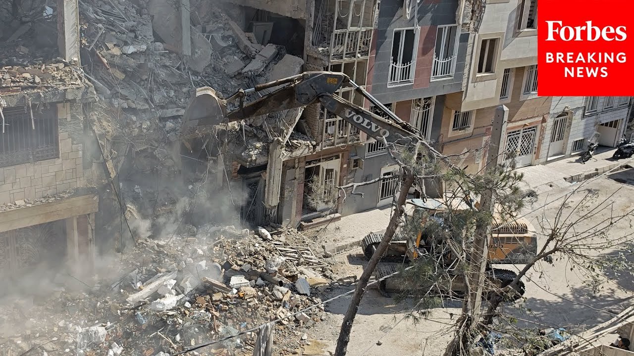 Crews Work To Clear Debris From Residential Building In Tehran Following Israeli Strikes