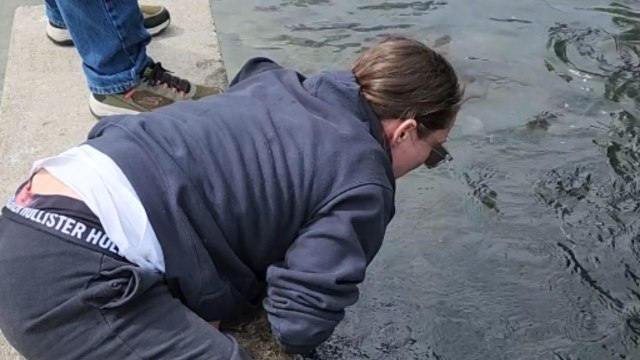 Girl realizes that she doesn't need a fishing pole when her hands work just fine!