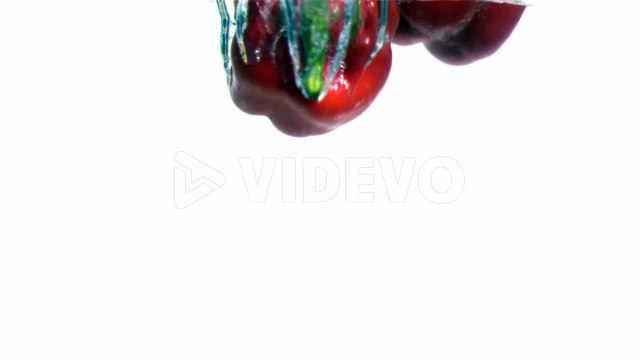 Peppers falling into water in super slow motion