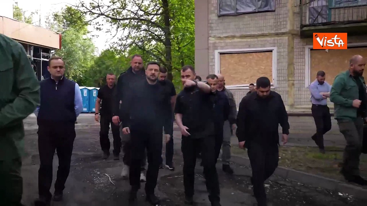 Zelensky depone un mazzo di rose rosse davanti a un palazzo distrutto dagli attacchi russi a Kiev