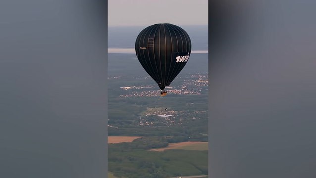 Russian daredevil performs gymnastics hanging from hot air balloon