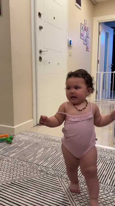 Toddler Giggles as Man Playfully Steps Over