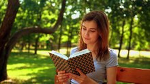 mixkit-girl-reading-a-book-in-nature-4897-hd-ready