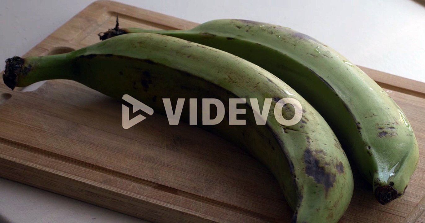 Cutting banana plantains in big pieces to boil