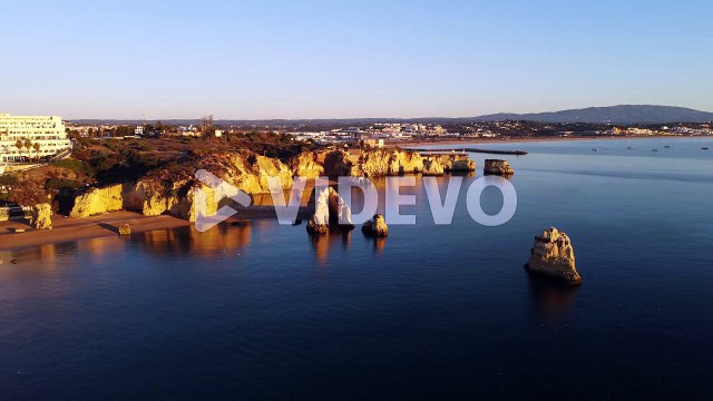 Aerial view, 4k drone shots, Praia Dona Ana with cliffs, Lagos at sunrise in autumn, in the Algarve, Portugal