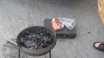 Gentleman fans coal with a slab but accidentally brings the whole grill down