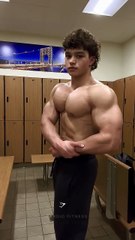 Pose demonstrating chest and bicep muscles for bodybuilder status.