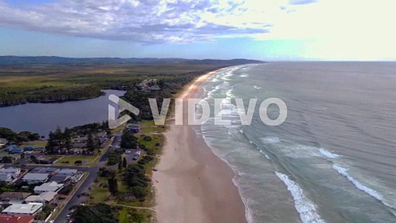 Lake Ainsworth By The Seaside In Lennox Head - Fresh Water Lagoon Infused With Tannins Of Surrounding Tea Trees - NSW, Australia - aerial drone