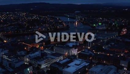 Fly above city in evening