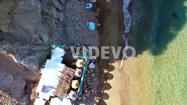 Hippie bar with umbrellas on nudist beach