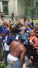 Diddy fans celebrate his verdict outside the courthouse by pouring baby oil on each other
