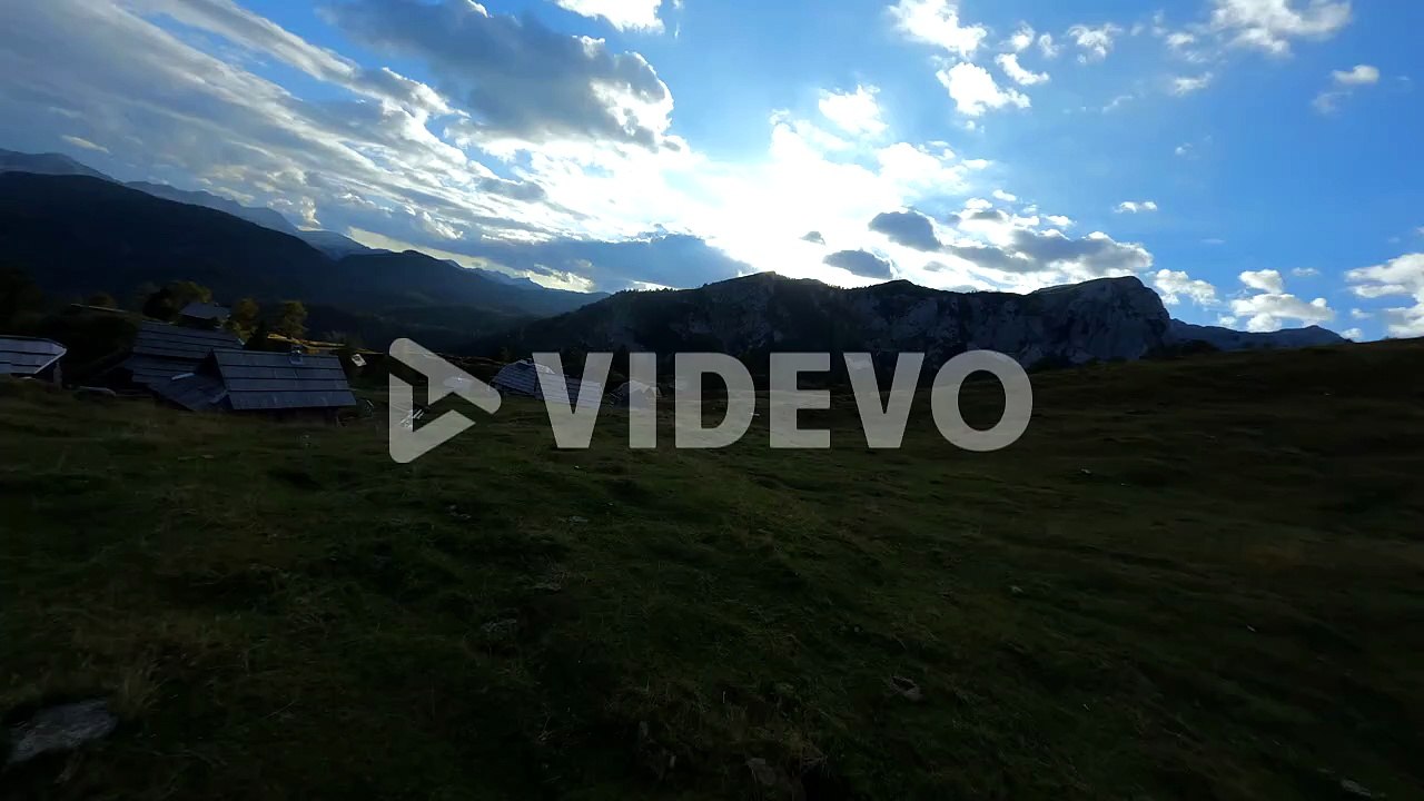 Fpv footage was filmed in the Slovenian mountain village in the alps with a drone flying fast over mountains filmed with a GoPro with surrounding landscapes flying between and over small wooden cabins-3