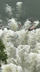 Two Kayakers Paddle Through Rapids