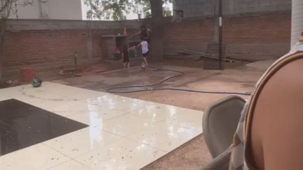 Kids slip and slide on wet floor while confidently racing across it
