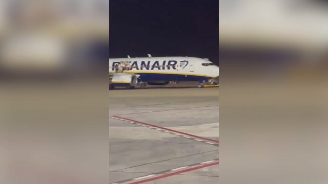 At least 18 injured as UK-bound Ryanair passengers leap onto wing after fire alert in Majorca