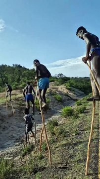 Walking on stilts Omo Valley Banna Tribe boys.
