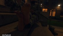 Female Soldier removing her combat boots and socks in uniform