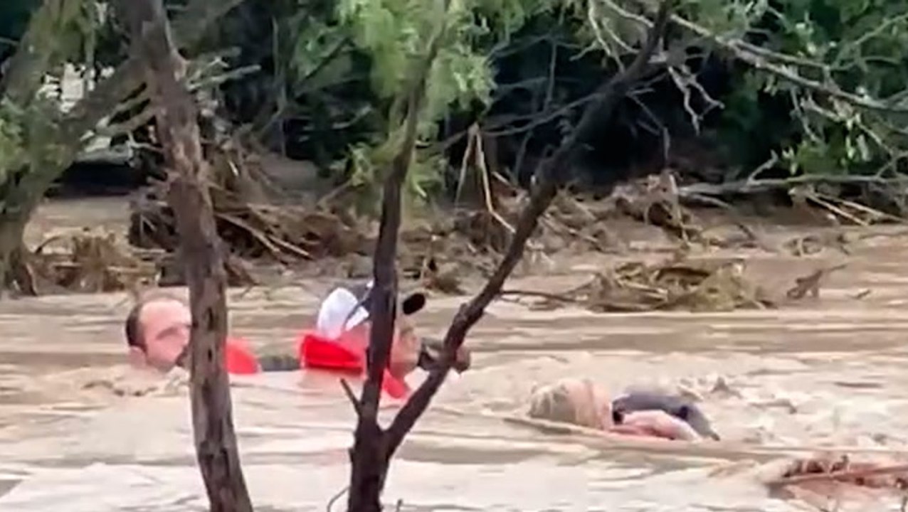 Residents cling to rope as Texas floodwater surges around them