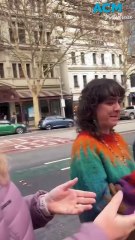 Hill of Content bookstore moves store book by book in human chain across Melbourne street