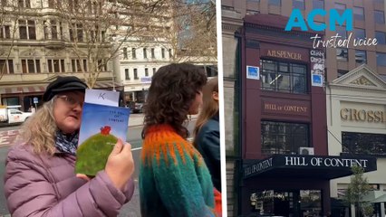 Hill of Content bookstore moves store book by book in human chain across Melbourne street