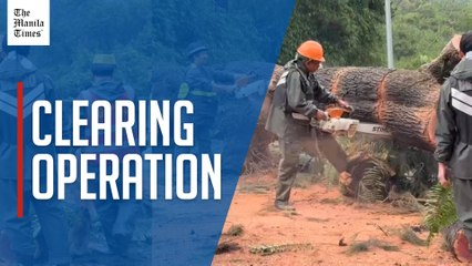 Govt workers clear Kennon Road of debris resulting from bad weather