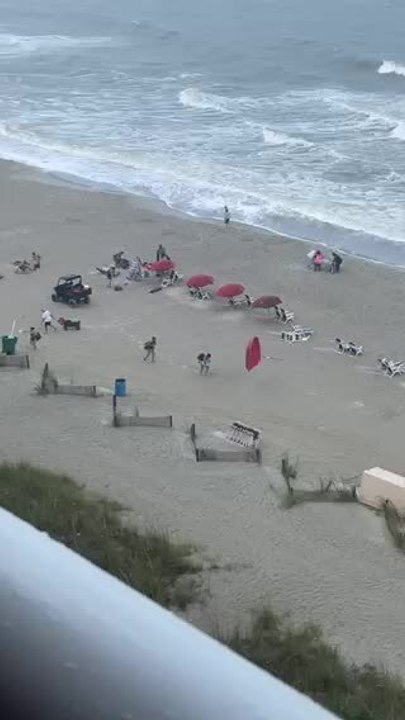 Wind Blows Umbrella Into Beachgoer