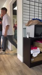 Man Startles Woman Behind Door and Gets Reflexive Hit