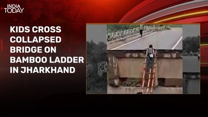 School children cross collapsed bridge on bamboo ladder in Jharkhand's Khunti