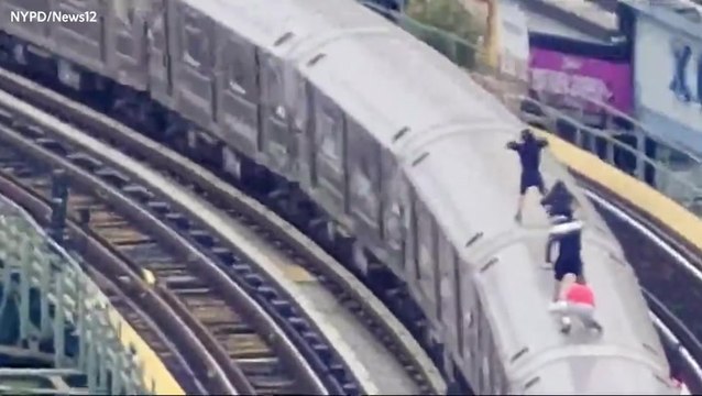 Young subway surfers caught travelling on top of moving train by police drone team