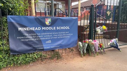 Floral tributes are left outside Minehead Middle School