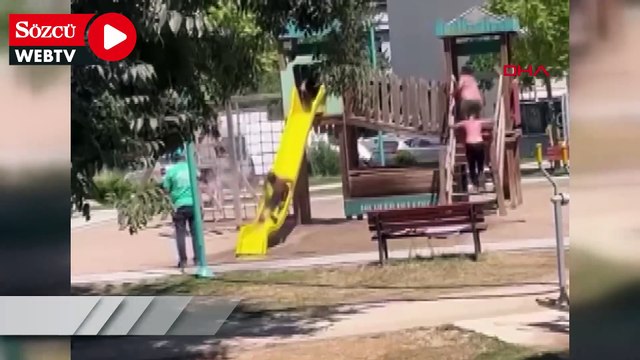 Sıcak havada parkta oynayan çocukları hortumla su sıkarak serinletti