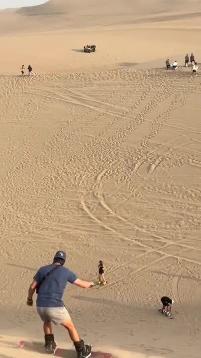 Man Gets Stuck and Falls While Sand Surfing