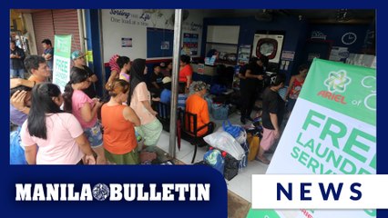 Residents take use of free laundry services after week-long rains in Quezon City