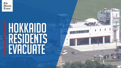 People shelter on roof as Japan issues tsunami evacuation warning