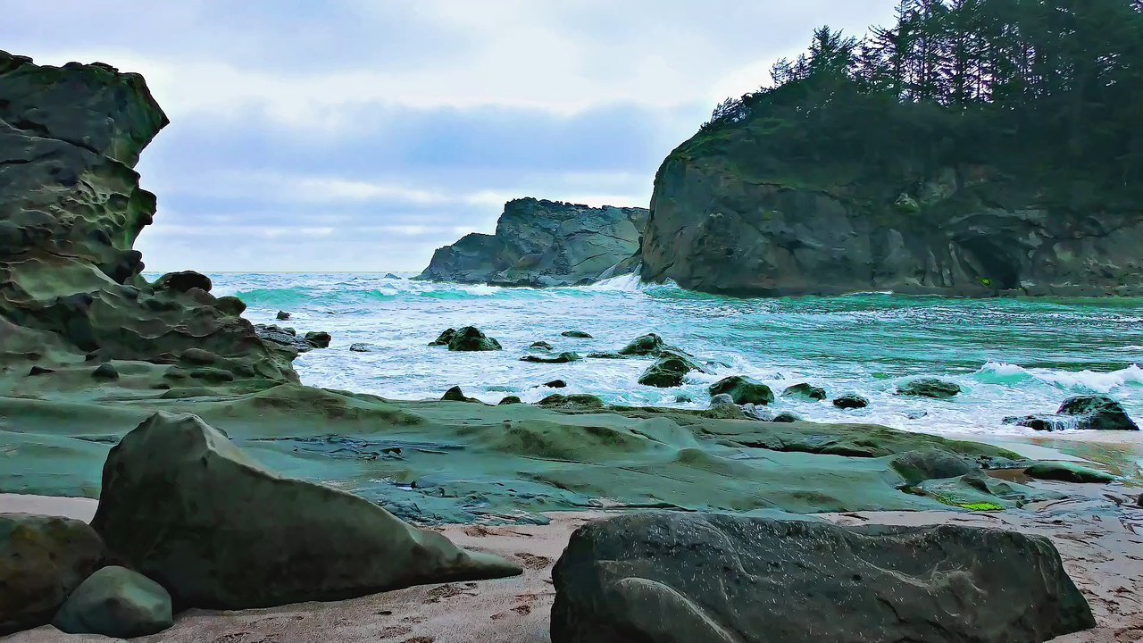 Beach View With Rock Formations And Waves