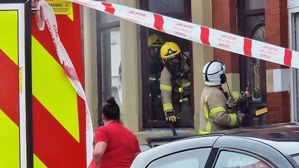 Firefighter breaks down door to tackle blaze as street is closed off