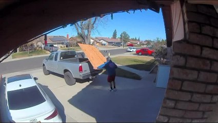 Strong Wind Causes Man to Lose Balance and Fall While Handling Wood