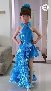 Little girl models dresses made out of plastic bags🥰