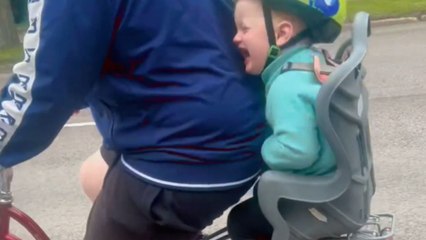 Child's laughter fills the air while riding through bumpy path on bike with her dad