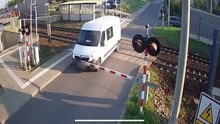 Van driver runs the red light and gets hit by a train