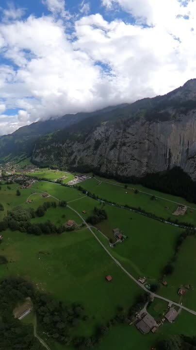 Two People Perform Wing Suit Base Jumping