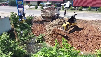 Perfectly compacted waste using a Komatsu D20A bulldozer earth mover, and garbage truck.