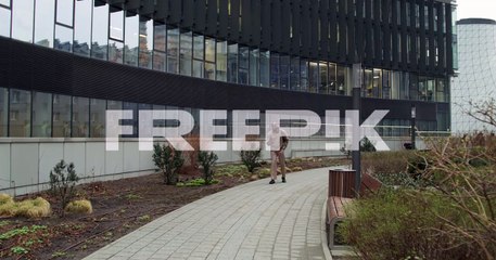man walking through city park