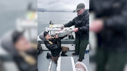 Woman Drinks Beer Through Body of a Salmon