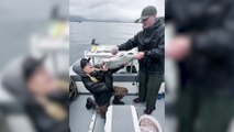 Woman Drinks Beer Through Body of a Salmon