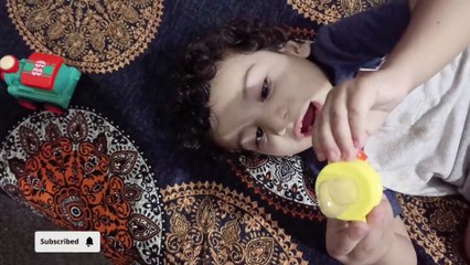 loaded diaper change, baby started playing with fruit pacifier