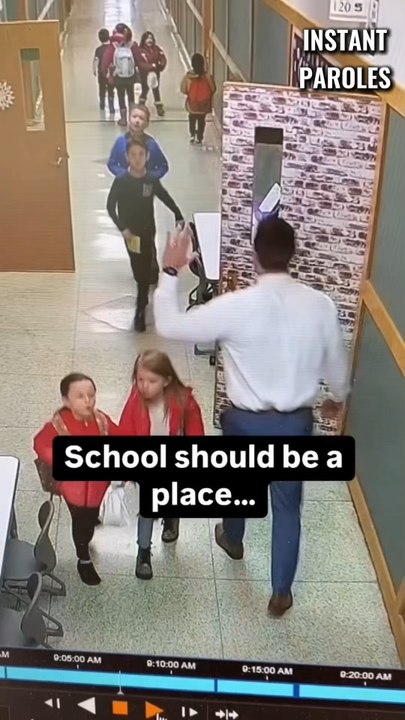 This principal greets students in the hallway