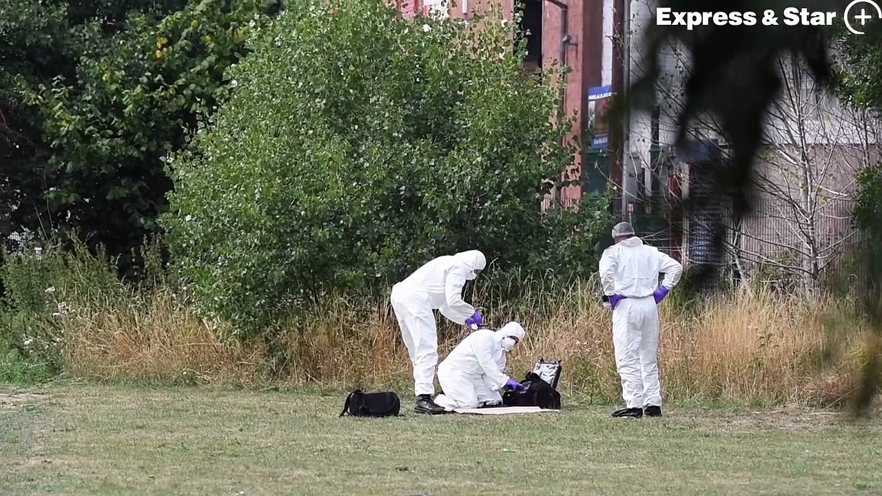 Police and forensics officers at the scene of a murder off Woodburn Road, Smethwick