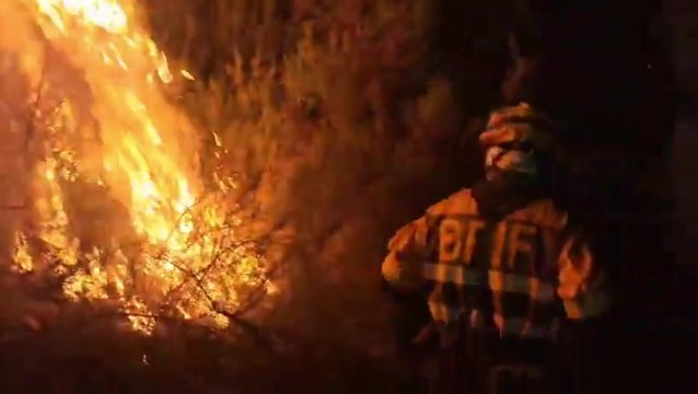 Firefighters come dangerously close to wildfires as they tear through northwestern Spain